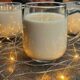Glass of homemade eggnog with nutmeg garnish.