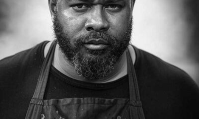 Black-and-white portrait of Travis 'Smoke Daddy' Wheeler, BBQ expert smoking brisket in Franklin, Tennessee