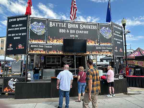 Battle Born Smokers booth with flags and signage at 2025 Rib Cook-Off