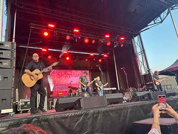 Sister Hazel performing on stage with red lights at 2025 Rib Cook-Off