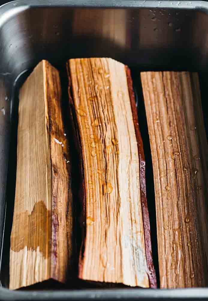 Hickory wood chunks soaked in smoker box for grill smoked brisket, ready for two-zone setup and terpene-rich flavor without bitterness
