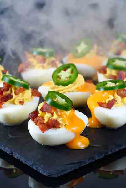 Bacon Jalapeño Smoked Deviled Eggs – Traeger & Pellet Smoker - Popular BBQ Bacon jalapeño smoked deviled eggs with cheddar and fresh jalapeño slice