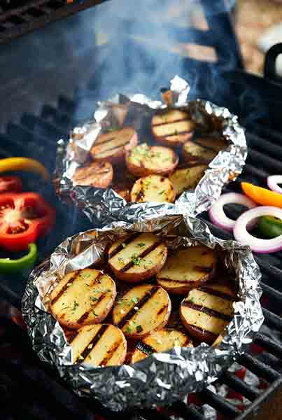 Grilled potatoes in foil with herbs and perfect grill marks