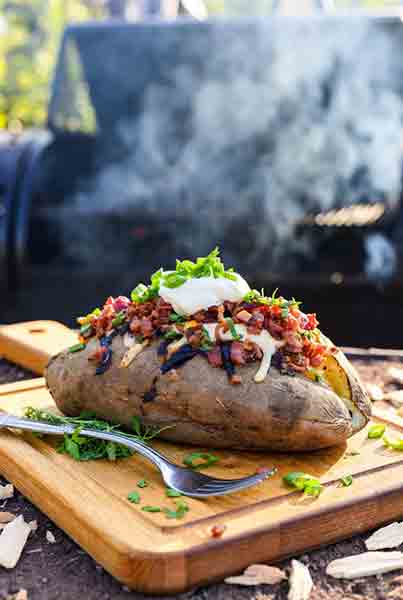 Ultra-fluffy Traeger smoked baked potatoes with crispy skin