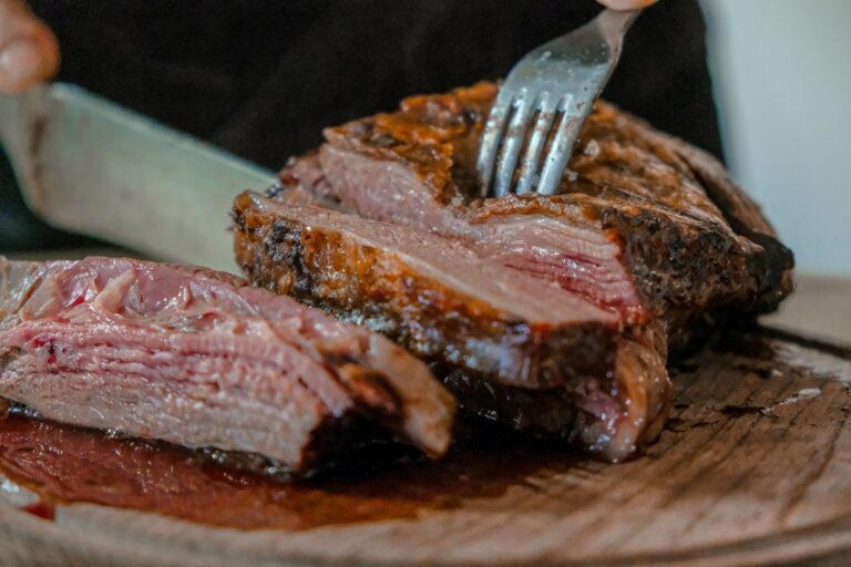 Sliced brisket on a wooden cutting board referencing USDA May 2026 wholesale pricing data for Memorial Day cookouts