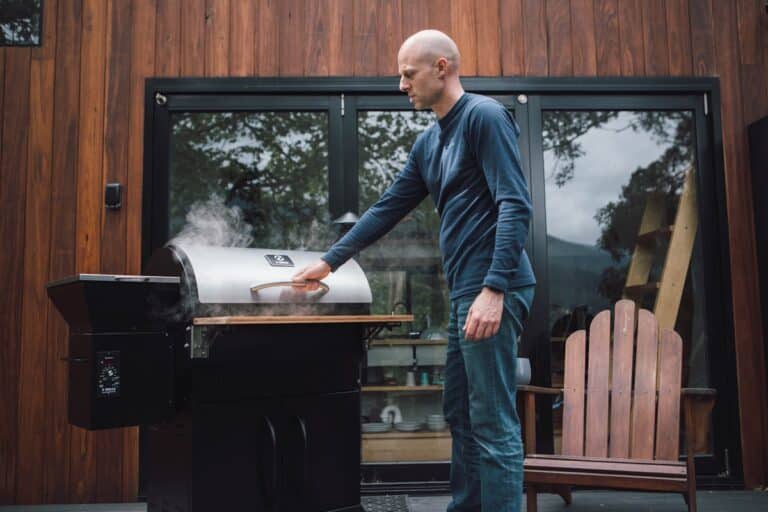 Pit Boss vs. Traeger pellet grill side-by-side comparison setup in a backyard