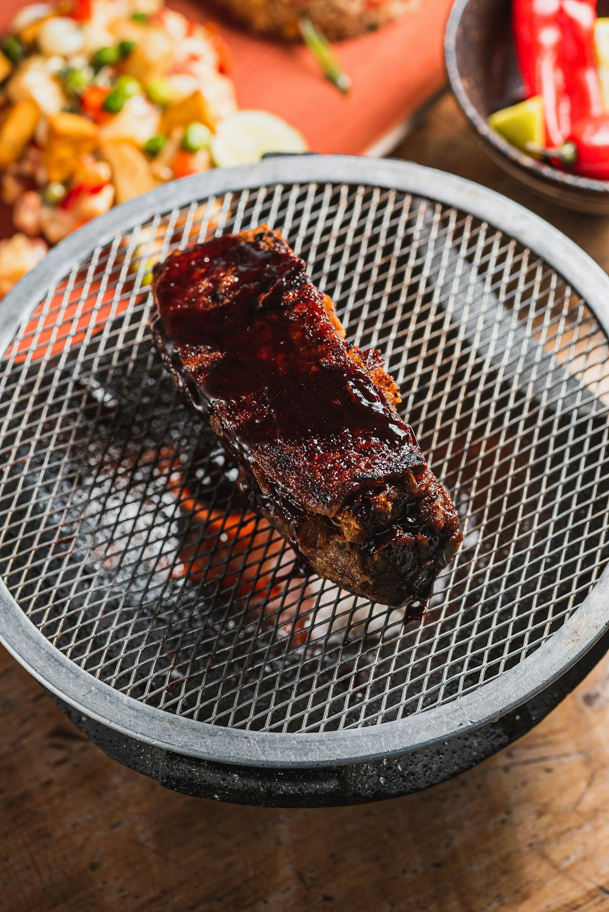 Rib King NYC 2026 — glazed pork ribs cooking on a grill