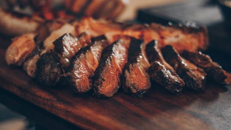 Sliced grilled tri-tip and beef brisket side by side for Memorial Day cookout comparison