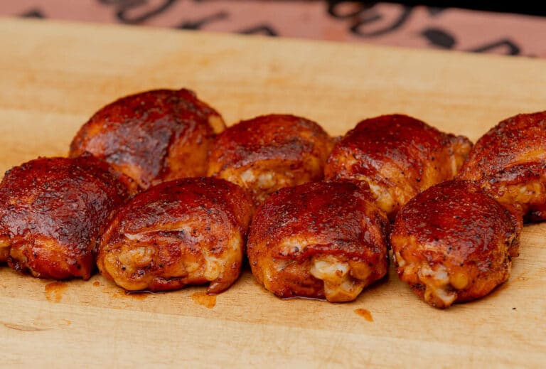 Competition-style smoked chicken thighs with glossy crispy skin