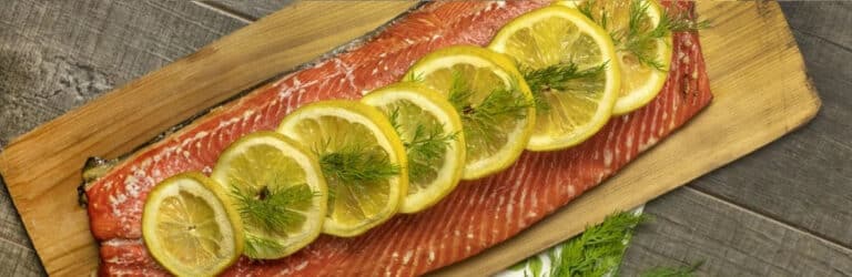 Hot smoked salmon fillet with lemon and dill on a pellet grill