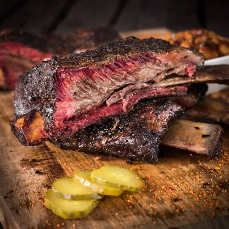 Smoked beef ribs with a dark bark, dino ribs