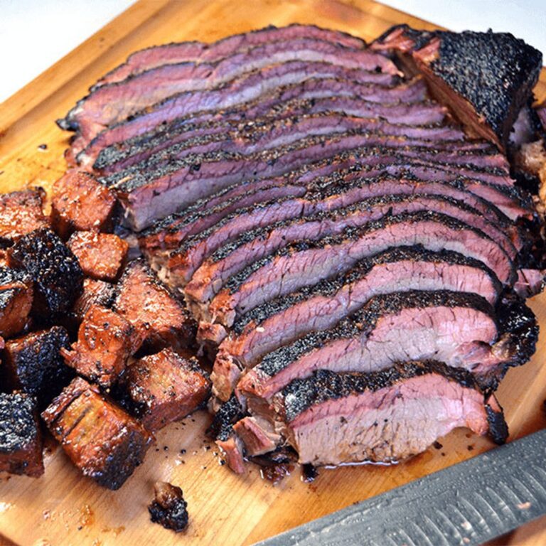 Sliced smoked brisket with dark bark and a deep smoke ring