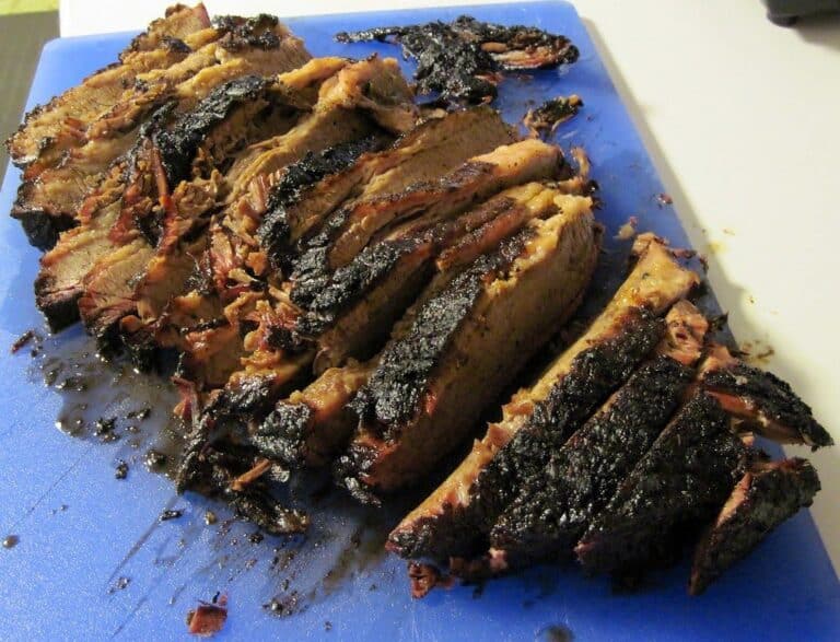 Sliced smoked beef with a dark bark — smoked chuck roast