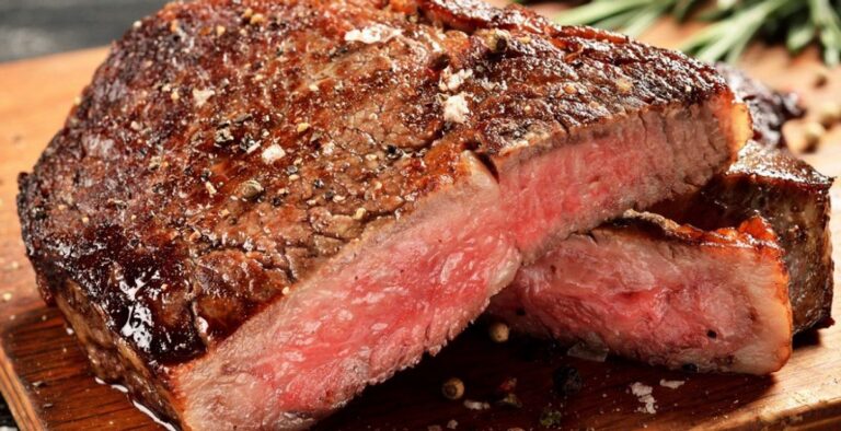 Reverse sear steak sliced to show an edge-to-edge pink center