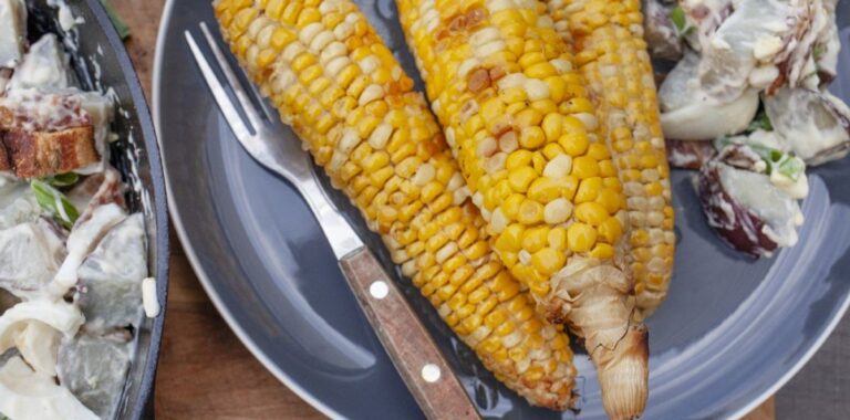Smoked corn on the cob with butter baste on the grill grate