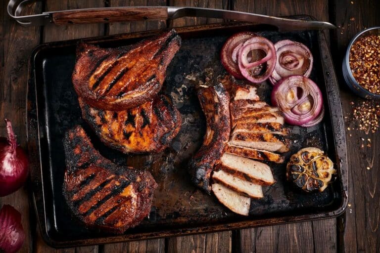 Thick-cut smoked pork chops resting after the sear