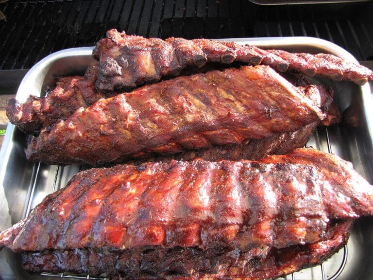 Homemade BBQ sauce brushed on glazed barbecue ribs