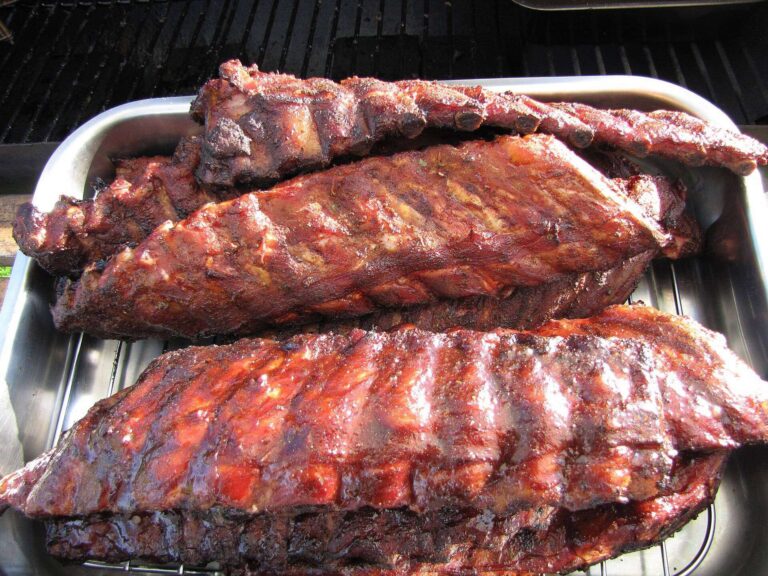 Homemade BBQ sauce brushed on glazed barbecue ribs