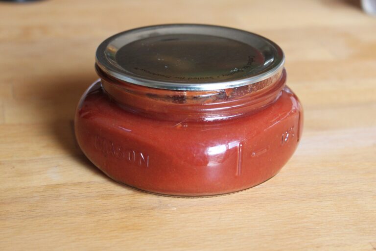 Homemade ketchup canned in a glass jar from garden tomatoes