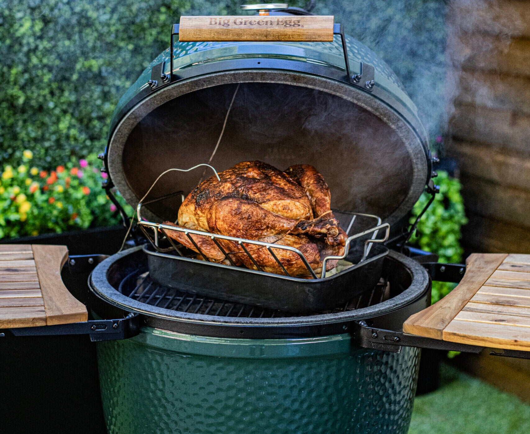 Turkey breast on a big green egg being smoked in the backyard - Popular BBQ Turkey breast on a big green egg being smoked in the backyard
